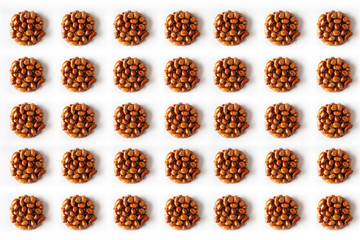 Pattern of tasty eastern sweets kozinaki made from peanuts and honey on a white background. Isolated.