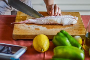 preparing anglerfish to be cooked (Lophius piscatorius)