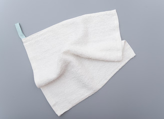 White bath towel on gray background