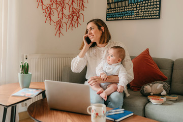 young business mother works from home with her cute baby