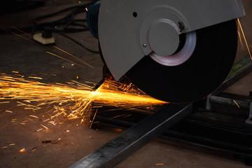 Steel cutter grinder are cutting iron pipe with bright sparks.