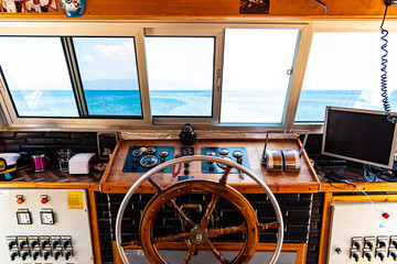 Captain's cabin with steering wheel and navigation equipment © Siarhei Kulikou