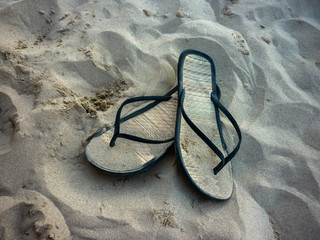 Close-up of bamboo flip-flops on the beach