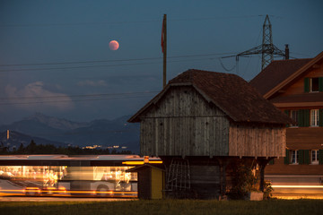 lunar eclipse red moon scenery in rural place lucerne