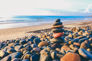 Close up of rocks stacked one on top of another with soft selective focus. Stones are naturally balanced on the background of the sea. High-quality free stock images of rocks and landscapes