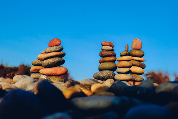 Close up of rocks stacked one on top of another with soft selective focus. Stones are naturally balanced on the background of the sea. High-quality free stock images of rocks and landscapes