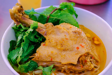 Mi Quang - The noodles with duck meat, vegetables, chili, peanuts, and seasonings with soft selective focus and blurred background. Mi Quang is a portion of Vietnamese cuisine. Food photography.