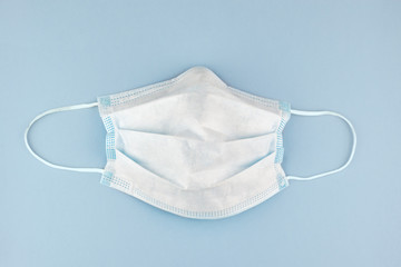 surgery protection mask against viruses, like coronavirus, on pale blue background