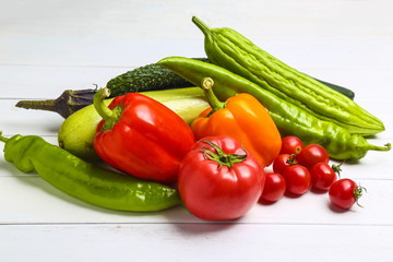 Fototapeta na wymiar various colorful vegetables on white wooden table