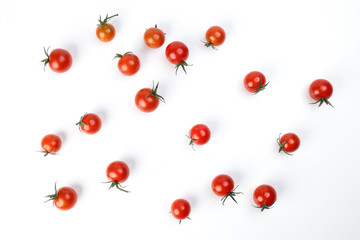 Red ripe cherry tomato with stem on white paper background copy text space