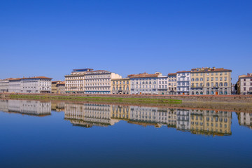 Fototapeta premium City houses with reflections in the Arno River, Florence, Tuscany, Italy