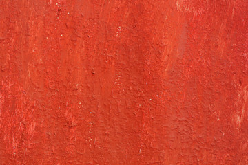 Beautiful vintage red background with old red paint with rough surface, streaks and uneven texture...