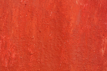 Beautiful vintage red background with old red paint with rough surface, streaks and uneven texture of red paint on old rough surface