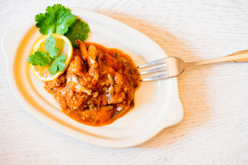 Homemade fish stew with tomato filling on the plate