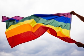 LGBT flag blown in the wind. Freedom and love concept. Pride month in June. 