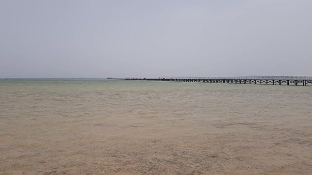 calm sea and Panton, stretching into the horizon. the sea is calm and lit by the bright sun. sand beach in the foreground