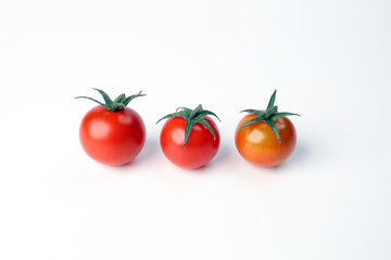 Red ripe cherry tomato with stem on white background