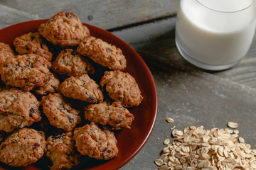 oatmeal cookies with a glass of milk in the background and oatmeal