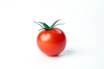 Red ripe cherry tomato with stem on white background