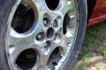 old chrome car wheels, ragged paint.