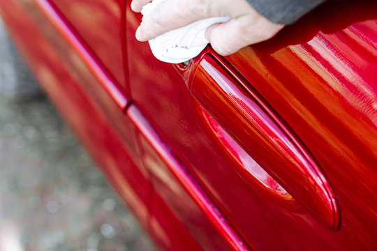 Polishing With A Duster Of A Red Car Body