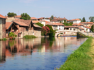 agricultural village overlooking the canal at the gates of Milan in the summer season.