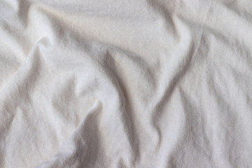 Fototapeta premium Natural cotton jersey fabric texture. Crumpled beige textile background