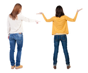 Back view of two pointing girl in sweater.