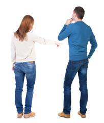 Back view of couple in sweater pointing.