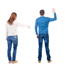 Back view of couple in sweater pointing.