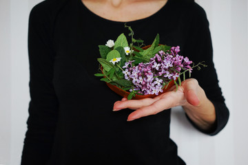 
flower arrangement in the shape of a heart in a female hand