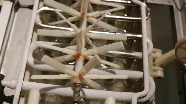 automatic ice-making plant close-up. A zigzag frost-frozen heat exchanger is heated to throw the finished ice into the hopper. plastic agitator starts to rotate