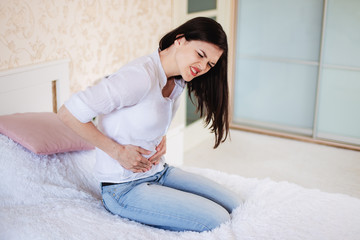 A young woman has a stomachache