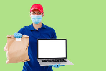 Delivery man in cap k t-shirt uniform face mask gloves hold cardboard box isolated on color background. Service quarantine pandemic coronavirus virus 2019-ncov concept