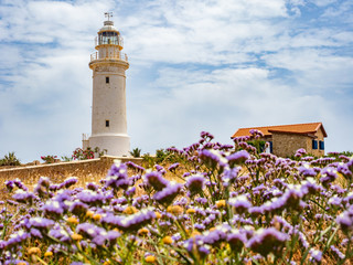 Pathos. Cyprus. White lighthouse on the background of the sky. Lighthouse on the Mediterranean Sea. Sights of the city of Pathos. Lighthouse in the archaeological park. Tours in Cyprus. Travels