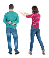 Back view of couple in sweater pointing.