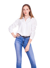 Obraz premium Portrait of a young beautiful blonde model in blue jeans and white shirt