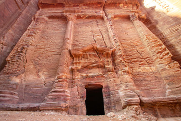 Carved sandstone facade of a tomb in Petra, Jordan