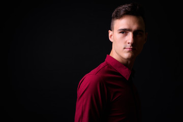 Portrait of young handsome businessman thinking and looking up