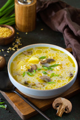 Diet and healthy eating concept. Royal Mushroom cream soup with bulgur on a dark stone background.