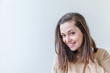 Happy girl smiling. Beauty portrait young happy positive laughing brunette woman on white background isolated. European woman. Positive human emotion facial expression body language.
