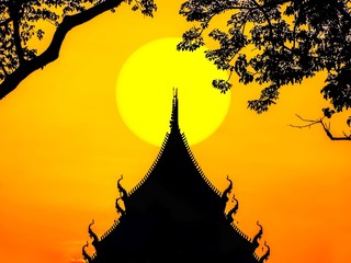The silhouette of the church roof and the tree has a yellow sky and sun background.