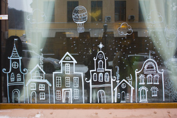 Cafe window with christmas decoration with cute houses in Kyiv