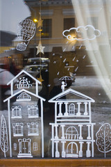 Cafe window with christmas decoration with cute houses in Kyiv