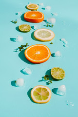 Top view. Citrus with ice on a blue background. Fresh  summer fruits. Copy space.