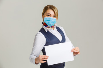 stewardess caucasian at plane with wearing protective medical mask. Girl tourist at aircraft with protect respirator. Concept virus protection coronavirus epidemic sars-cov-2 covid-19 2019-ncov.