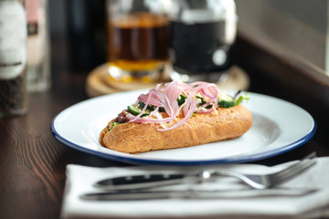 Appetizing hot dog with red onion and cucumber 