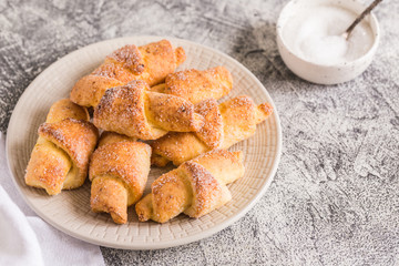 homemade cottage cheese mini croissants on a gray concrete background. breakfast with croissants