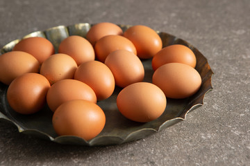 Fresh brown eggs on metal tray