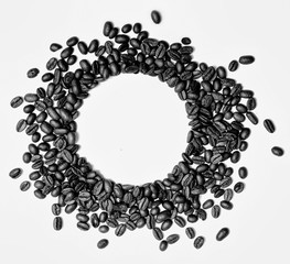Circle frame of roasted brown coffee beans isolated on white background may use as background or texture.